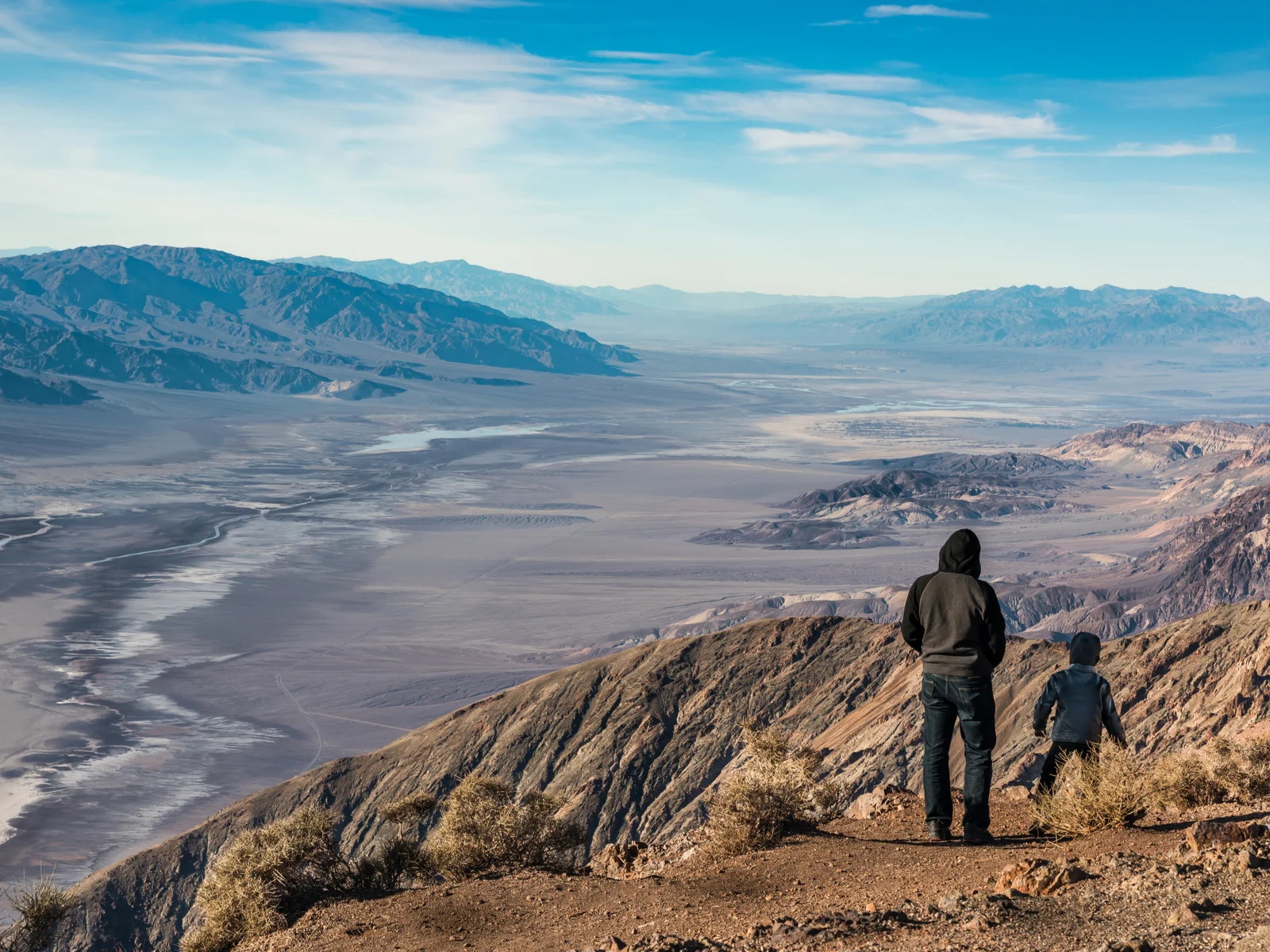 Guy hiking with his son in the morning during the best time to visit Death Valley National Park