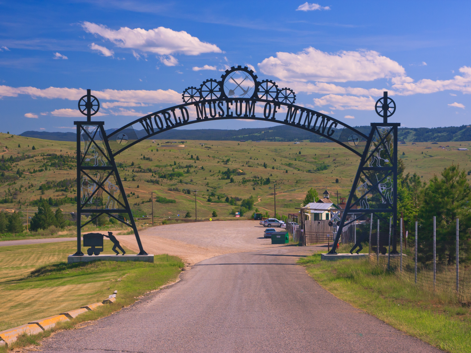 A creative welcome arch with gears and pictures of miners performing regular tasks at World Museum of Mining, our pick on one of the best things to do in Montana