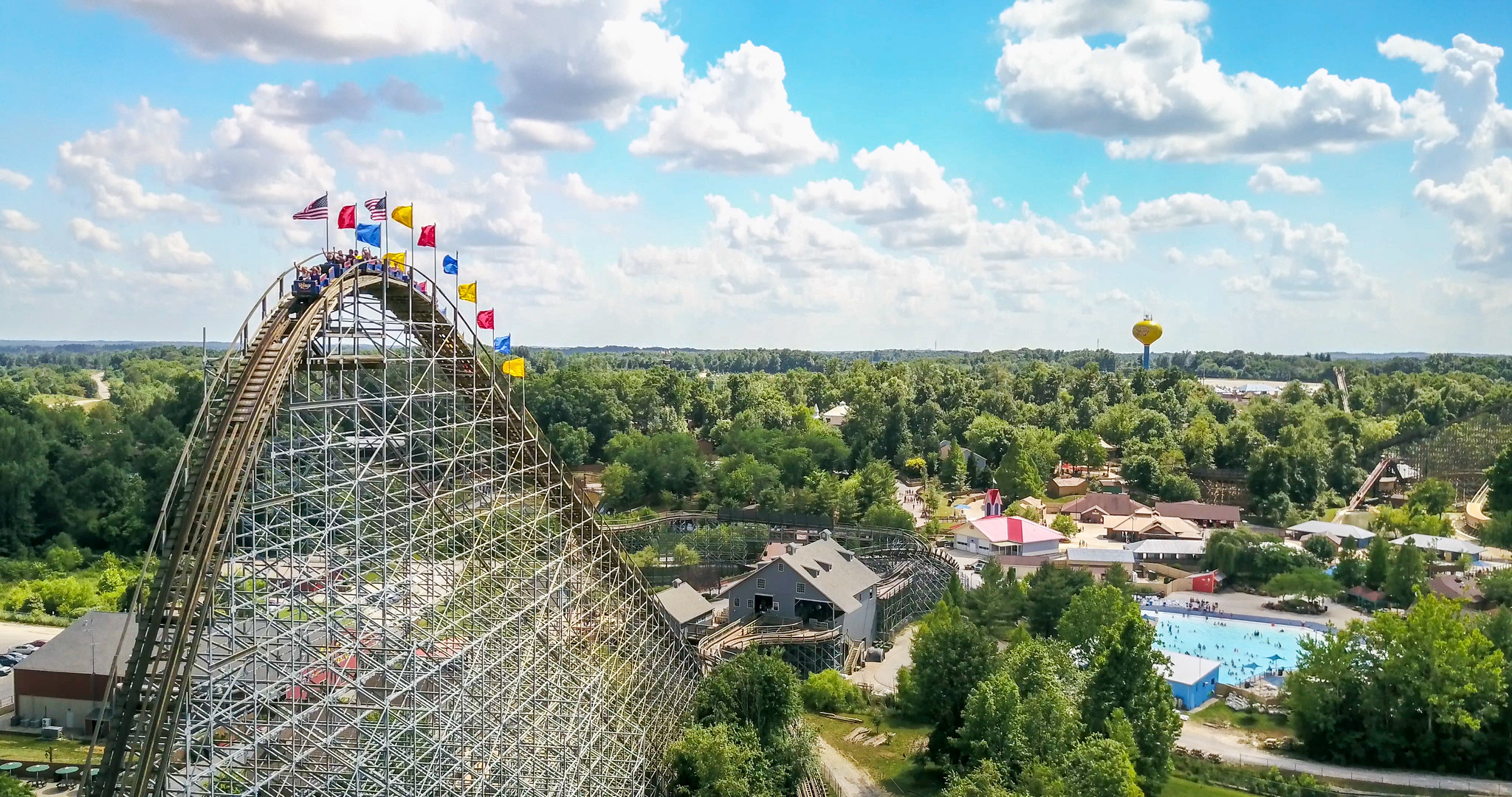 Visitors are thrilled as the Voyage Wooden Roller Coaster in Holiday World & Splashin' Safari in Santa Claus, Indiana, one of the best roller coaster parks in the US, as the ride prepares to plunge
