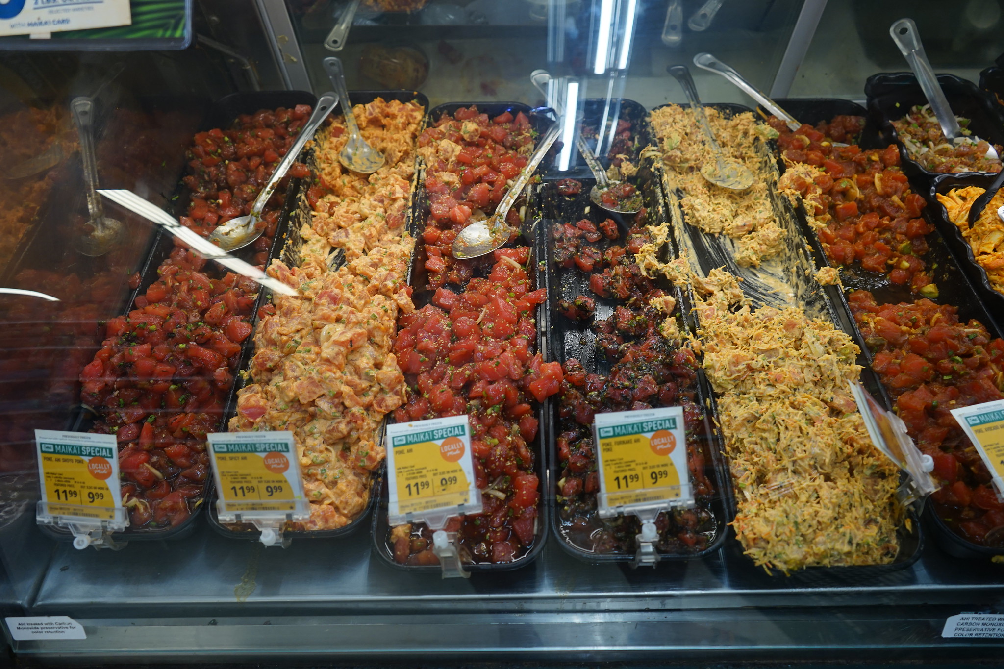 A lot of choices for building your own Poké Bowl with each having its own serving spoon at Poké Bar, named one of the best restaurants in Oahu