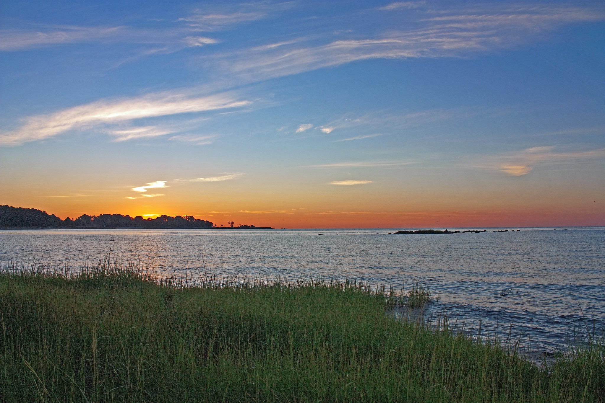 Sunrise over the grassy Westport Compo Beach in Connecticut, one of the best beaches on the East Coast