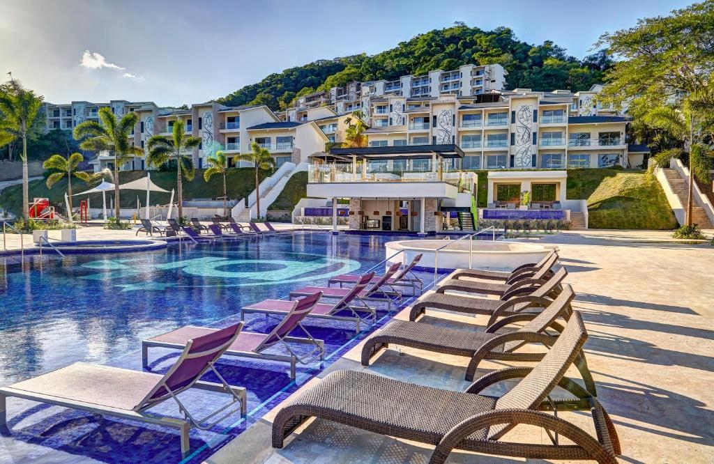 For a piece on the best all-inclusive resorts in Costa Rica, the pool and gorgeous rooms overlooking the pool at Planet Hollywood Costa Rica, An Autograph Collection