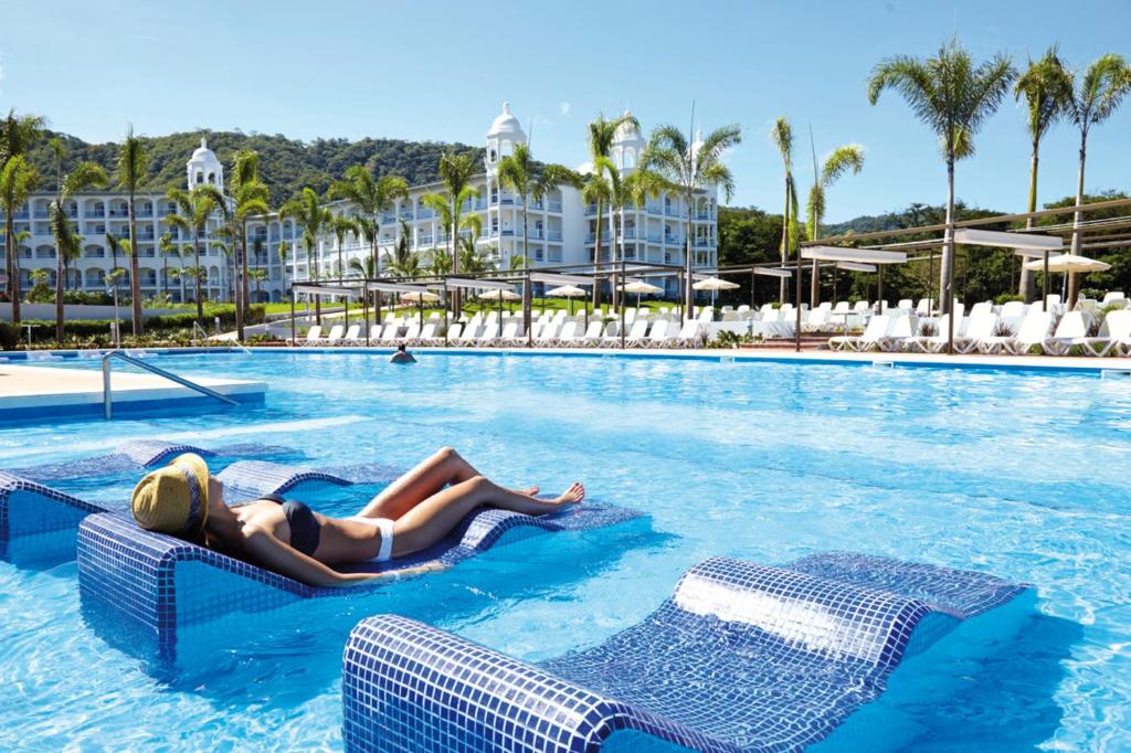 Woman sunbathing at one of the best all-inclusive resorts in Costa Rica, the Riu Palace in Coco