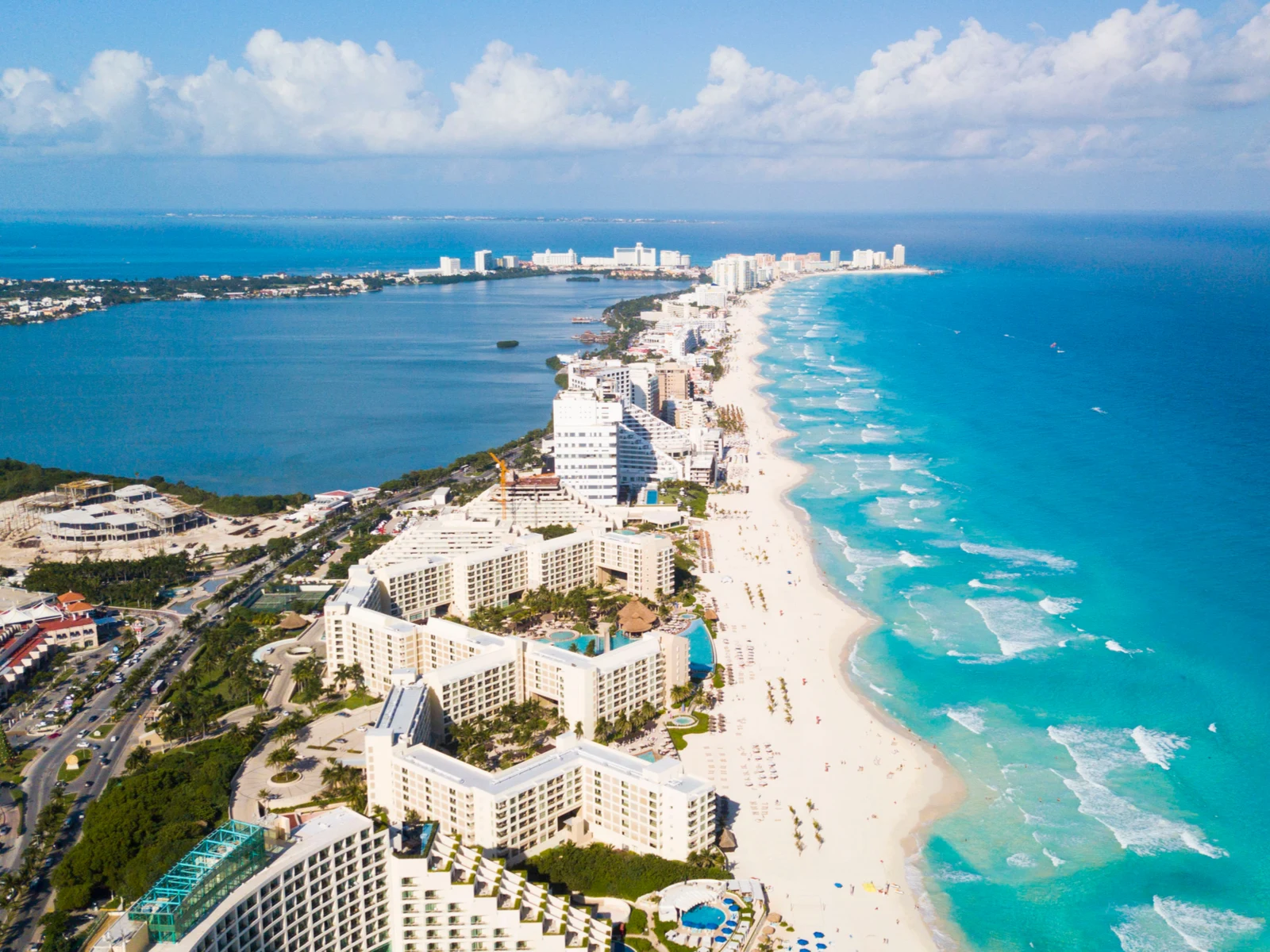 Aerial view on series of luxuries hotels, the best all-inclusive resorts in Cancun for families, lined up at a turquoise beach 