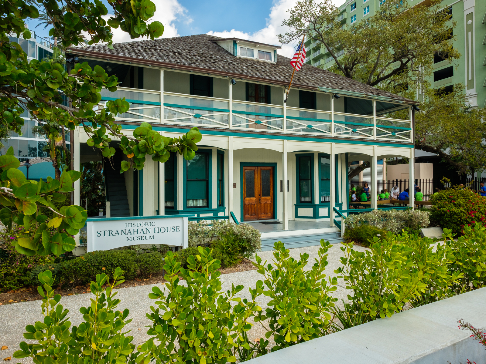 A beautiful view of Stranahan House Museum as a piece on one of the best things to do in Fort Lauderdale, with a few people waiting to get admission 