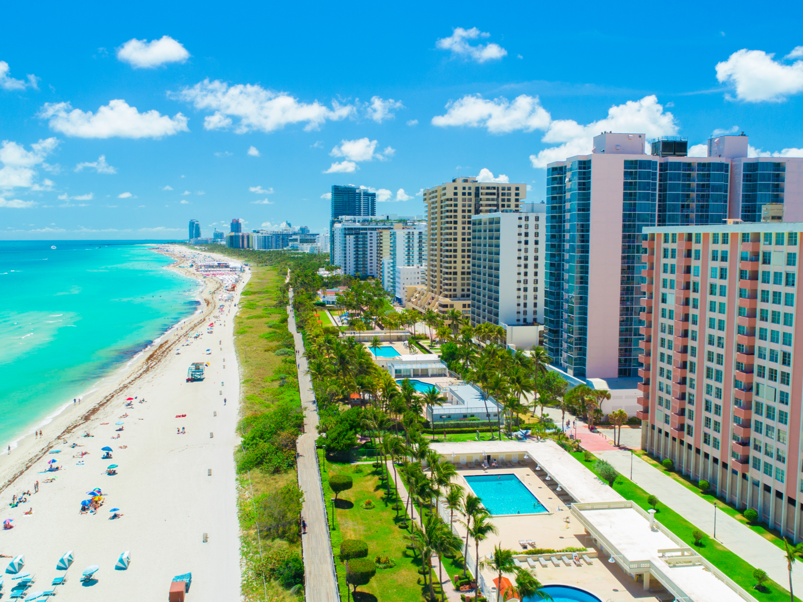 Aerial shot on the beautiful and well-designed landscape at Miami Beach, one of the best beaches in the US, where beach area, walk area, and hotels and resort area are well-placed