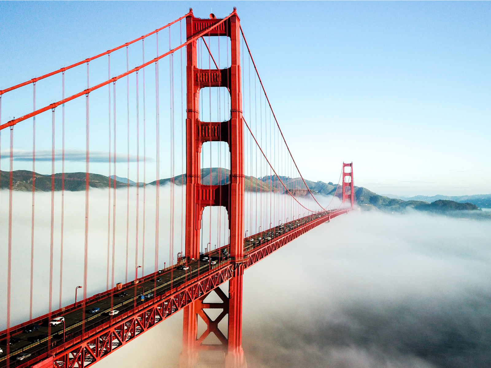 Misty morning at the Golden Gate Bridge in San Francisco, a piece on the most iconic places in America, where cars are seen traversing the bridge