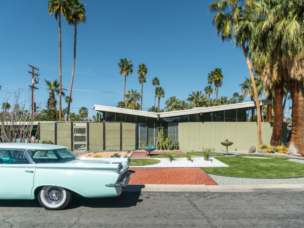 Classic car outside of a typical mid-century modern home in Palm Springs California on a clear day