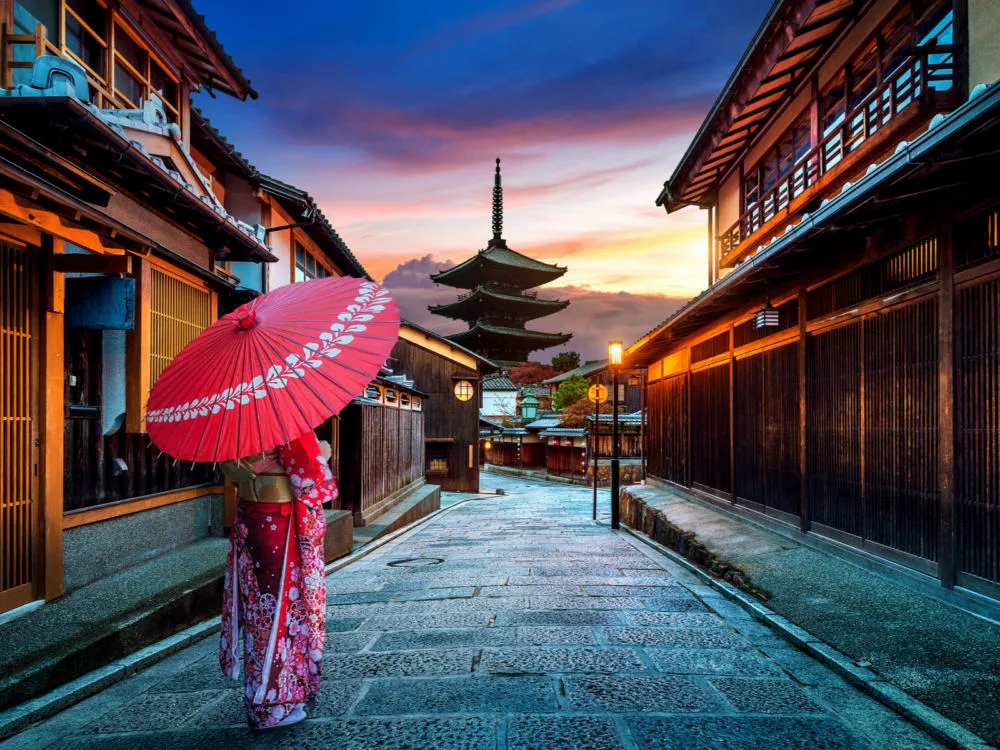 Woman walking down the street in a kimonon at Yasaka Pagoda and Sannen Zaka Street in Kyoto during the least busy time to visit Japan