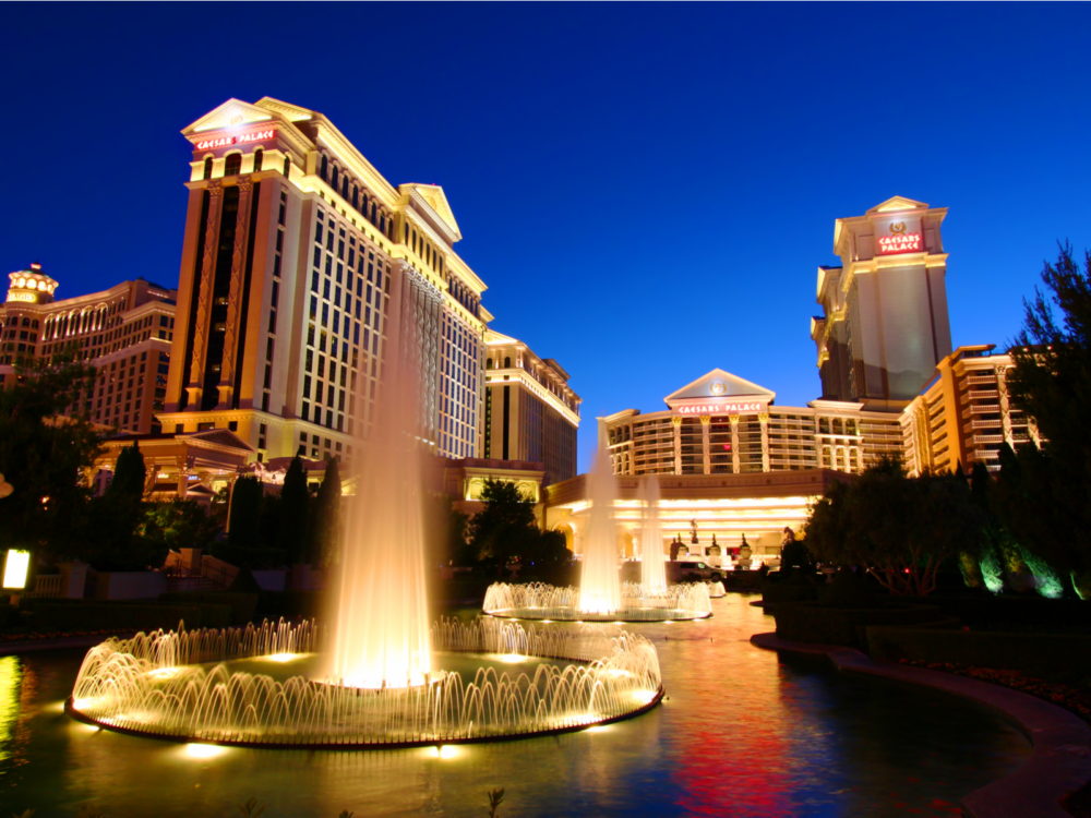 Night view of the Caesars Palace and Bellagio fountain for a piece on the best and worst times to visit Las Vegas