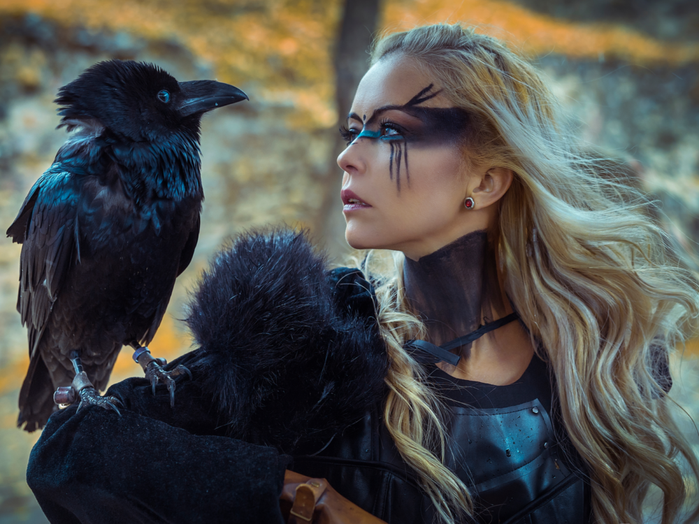 Woman with a black crow on her shoulder cosplaying at one of the best Game of Thrones filming locations to visit