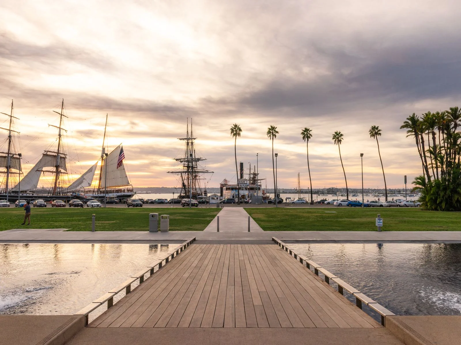 Road to the harbor over the water with sailing ships in the background during the best time to visit San Diego