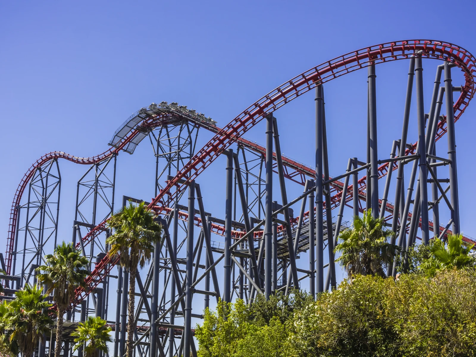 A roller coaster ride at the peak of its sophisticated rails at Six Flags Magic Mountain in Valencia, California, one of the best roller coaster parks in the US