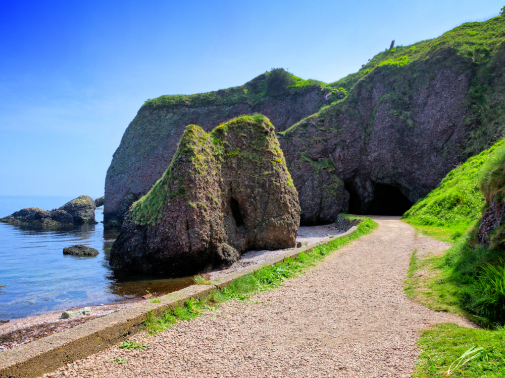 A huge boulder at Causeway Coast along a path leading towards the Cushendun Caves in Northern Ireland, one of the most notable Game of Thrones filming locations you can visit