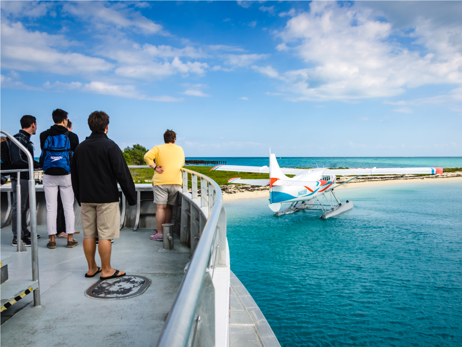 A group of five watching a seaplane from a ferry at Key West Seaplane Adventures, one of the best things to do in Key West