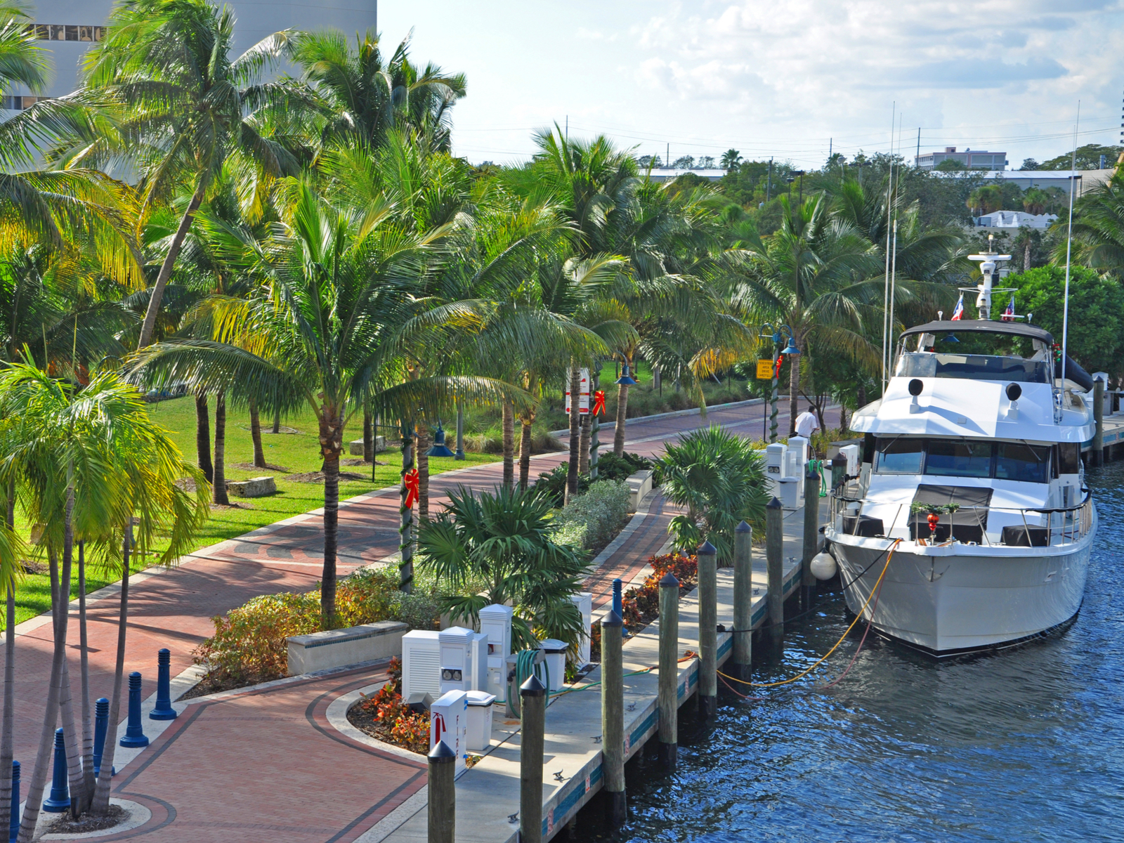 A small white boat docked for a boat tour, one of the best things to do in Fort Lauderdale