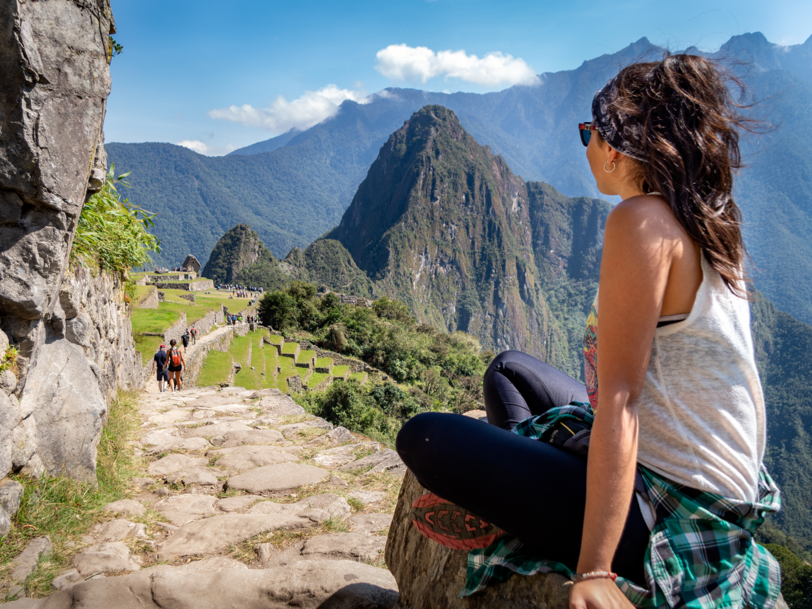 Woman looking out over the mountain range during the best time to visit Machu Picchu