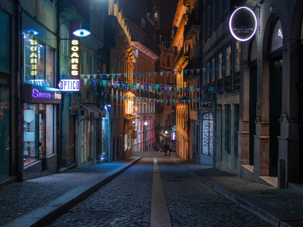 Portugal street pictured at night looking down a dimly lit alleyway