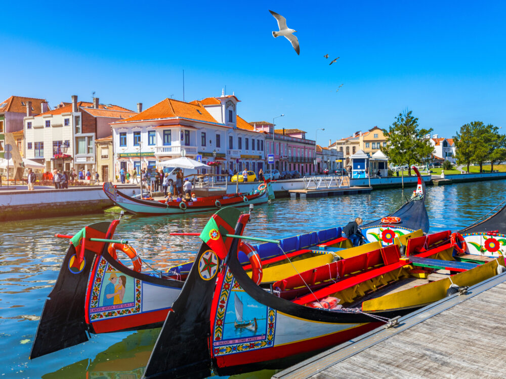 Two traditional boats on the canal in Aveiro pictured during the best time to visit Portugal