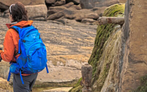 Woman wearing an Osprey backpack while hiking through western Australia
