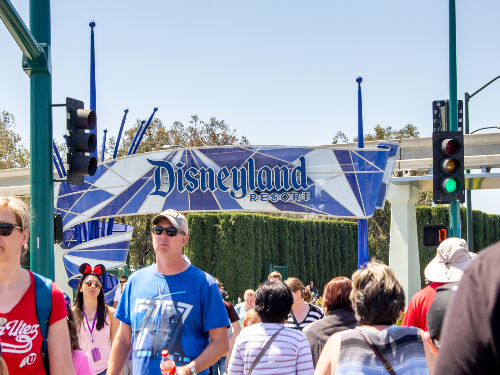 Multiple tourists crossing a street toward Disneyland theme park, one of the best things to do in California