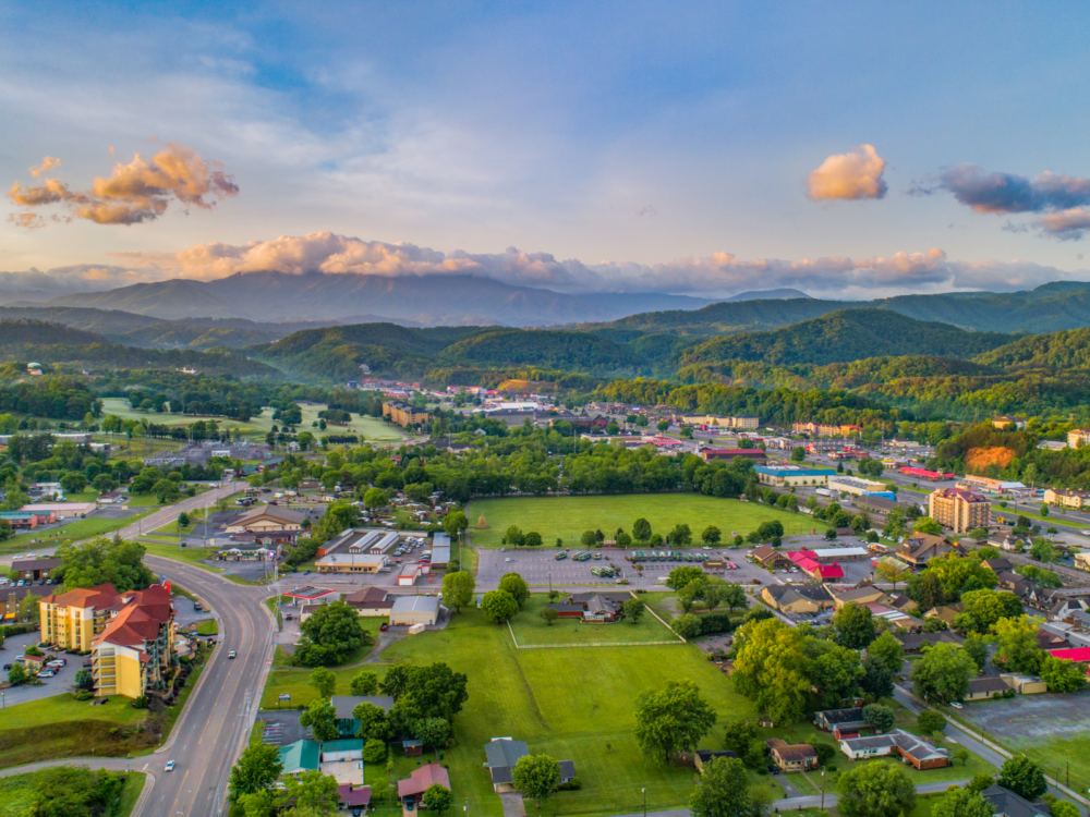 a stunning aerial view of houses, attractions, facilities and green fields which offers many things to do in pigeon forge