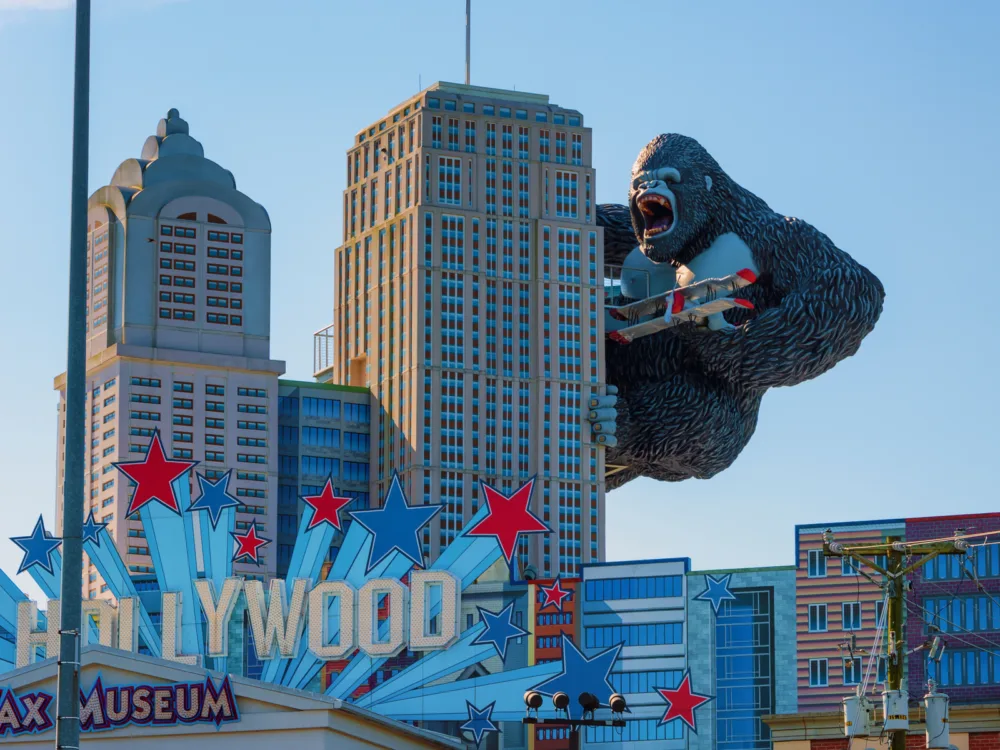 For a piece on the best things to do in Pigeon Forge, pictured is a gigantic figure of king kong climbing a building and holding a plane in hollywood wax museum