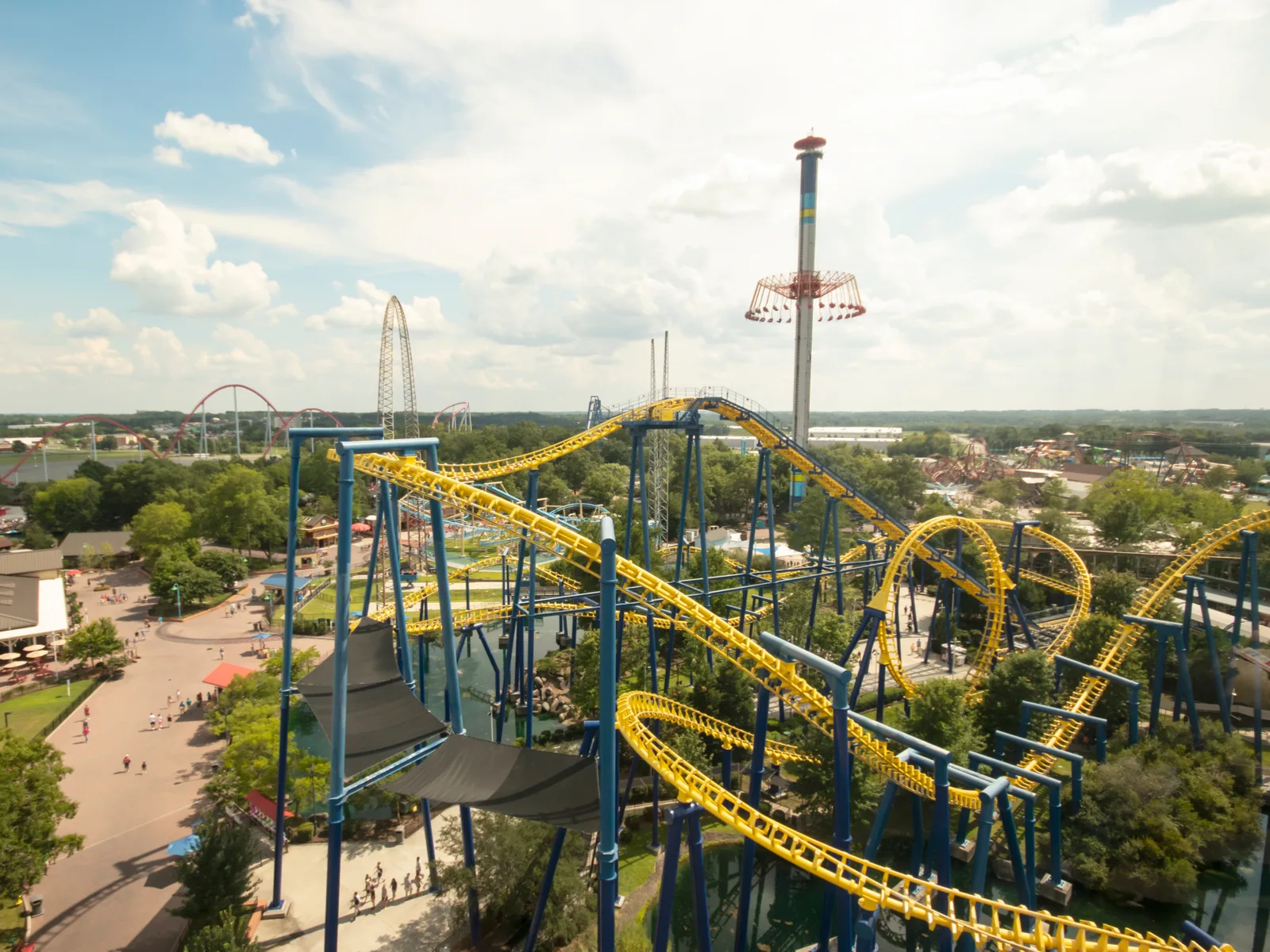 Aerial view of the Carowinds in Charlotte, North Carolina, the best place to go during summer and one of the best roller coaster parks in the US, with its yellow roller coaster tracks and other rides
