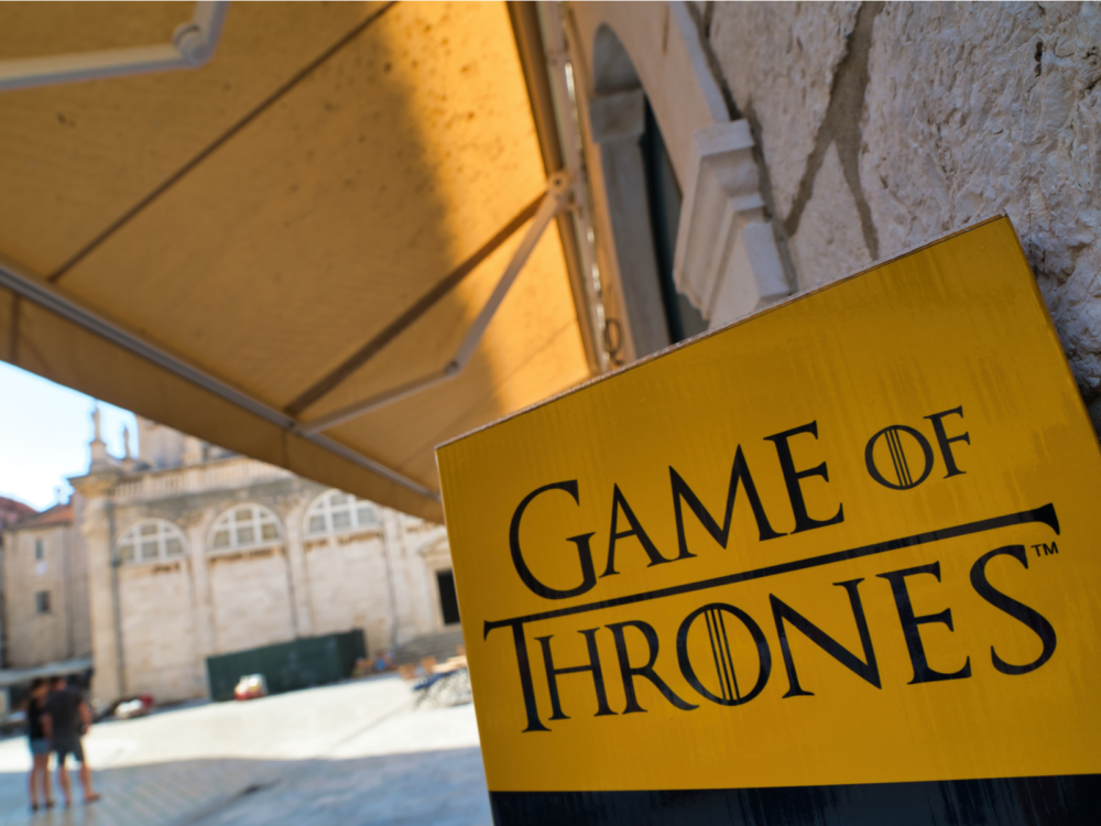 A yellow Game of Thrones sign at a set in Dubrovnik, Croatia, one of the Game of Thrones filming locations you can visit