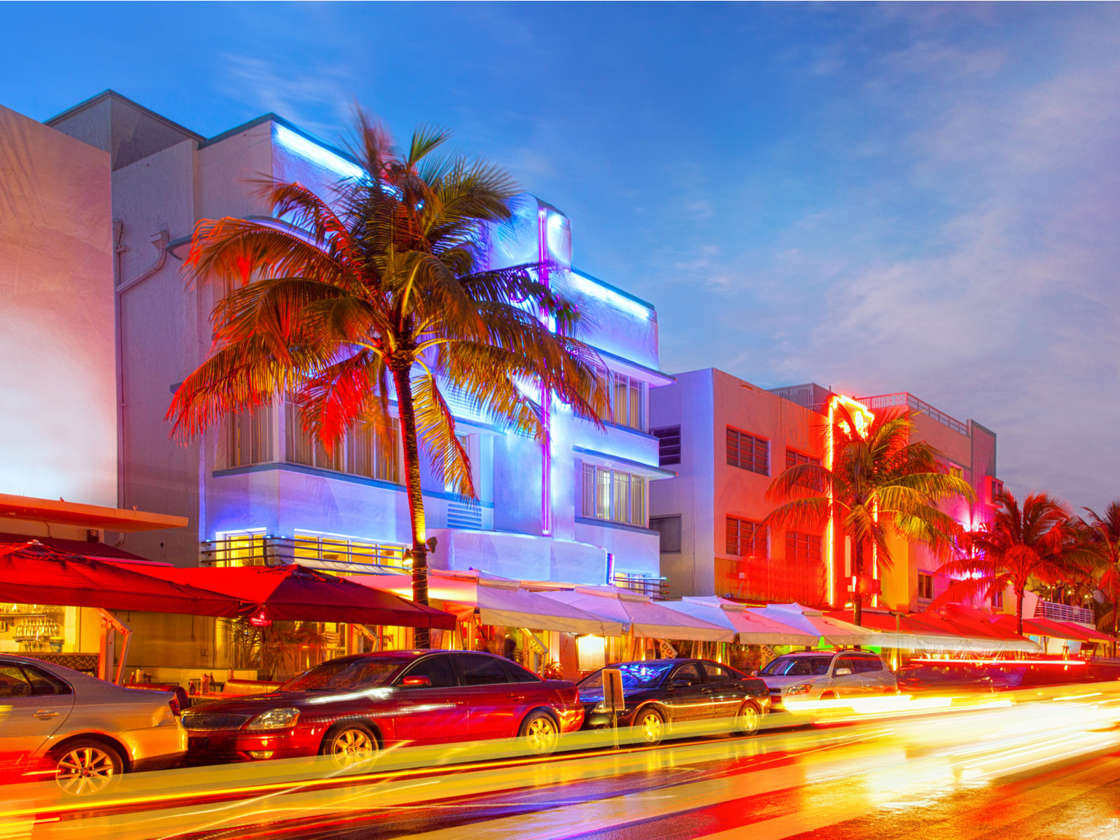 The downtown strip on Ocean Drive illuminated at night during the cheapest time to visit Miami