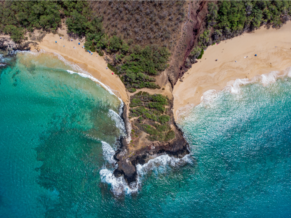 Overhead view on the two beaches divided by a mass of land, an iconic landmark at Makena State Park in Hawaii and one of the best beaches in the US