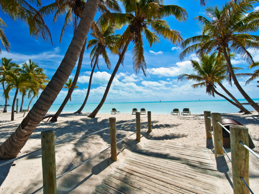 Photo of a beach in the Florida Keys, one of the best beaches in the United States, pictured from a footbridge to the ocean
