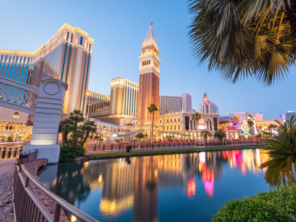 The bright cityscape at dusk along the strip, reflected on the reflection pool, at Las Vegas in Nevada, considered one of the most beautiful cities in the US