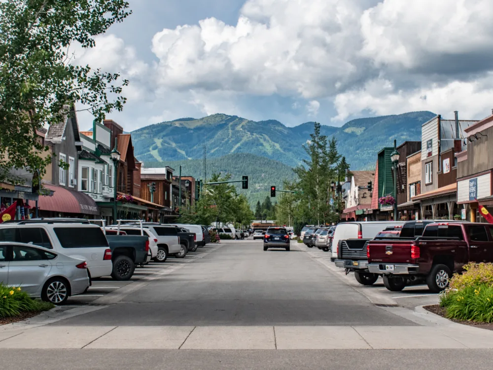 Empty street of Whitefish with clouds over the mountain range during the least busy time to visit Montana