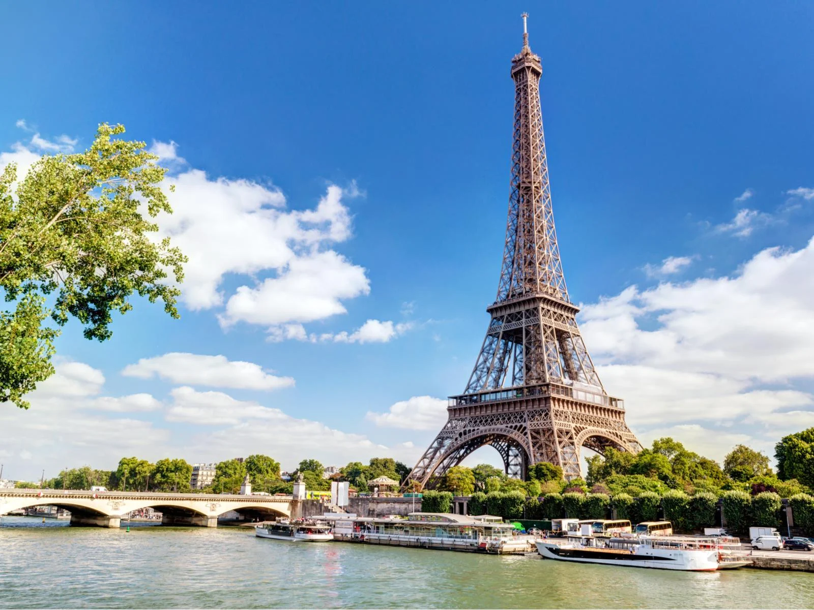 River bank view of the Eiffel tower on a Summer day during the best time to visit Europe