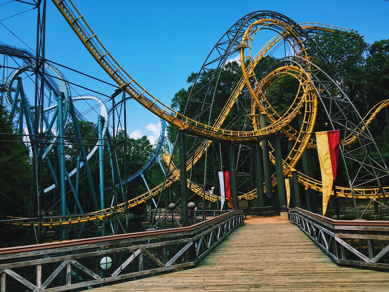 Complex winding roller coaster rails over a boardwalk at Busch Gardens in Williamsburg, Virginia, one of the best roller coaster parks in the US