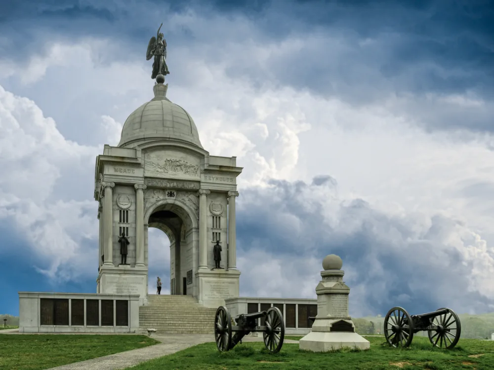 Heavy clouds over two old war cannons in front of the Pennsylvania Memorial in Gettysburg, one of the most iconic places in America