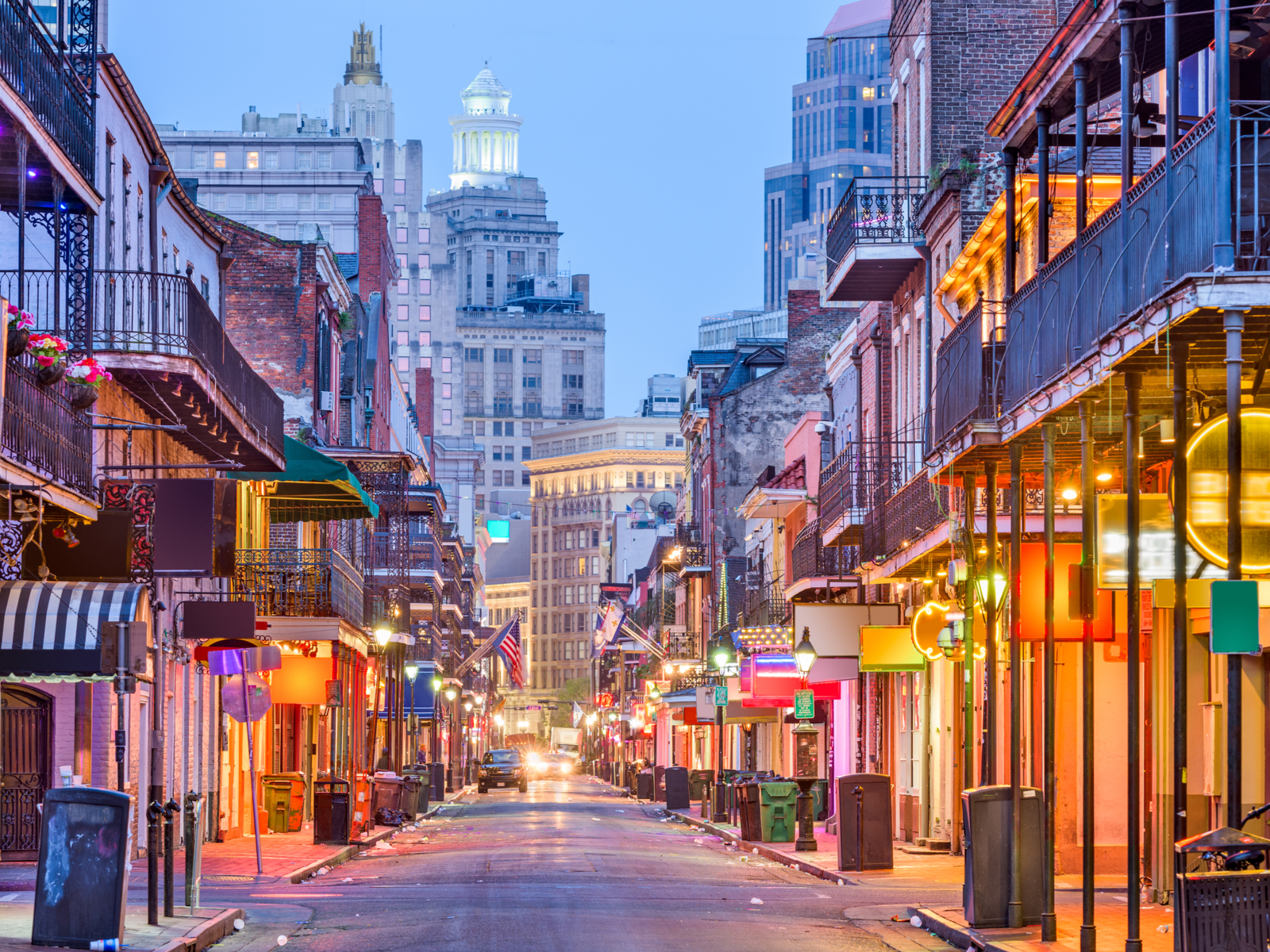 The Bourbon St with lit stores and bars during dusk at New Orleans in Louisiana, considered one of the most beautiful cities in the US