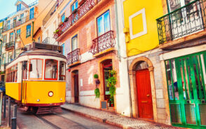 Vintage yellow tram in Lisbon pictured for a piece titled Is Portugal Safe to Visit