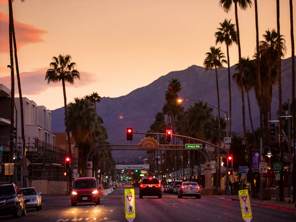 A busy street down the Palm Canyon Drive at dusk, one of the best things to do in Palm Springs as it has multiple leisure activities during day and night