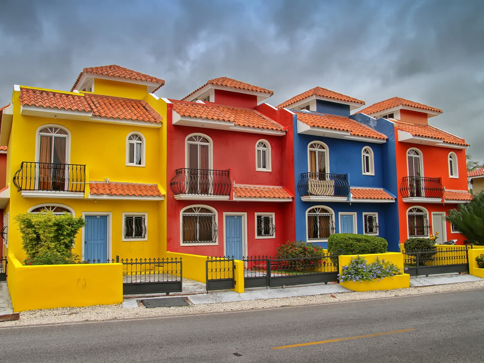 Multi-colored homes pictured against a cloudy sky during the worst time to visit Punta Cana
