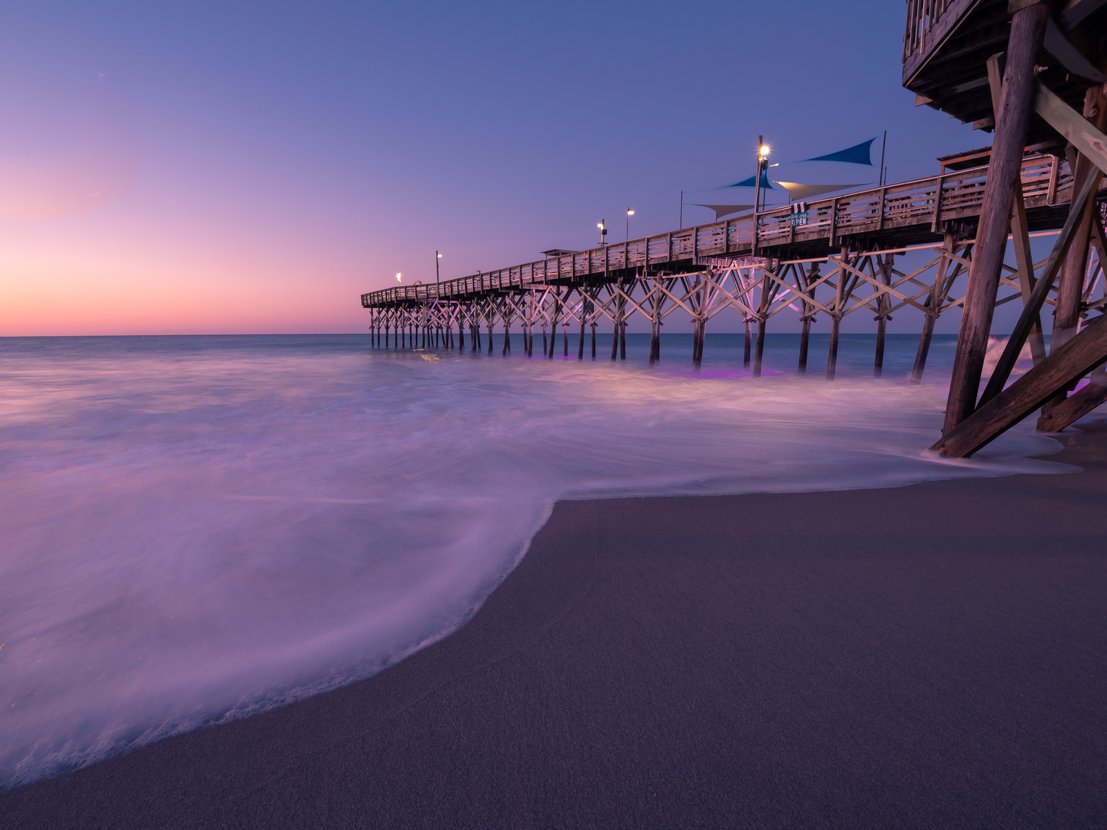 Pretty night view with a purple sky with the sun setting over the pier during the least busy time to visit Myrtle Beach