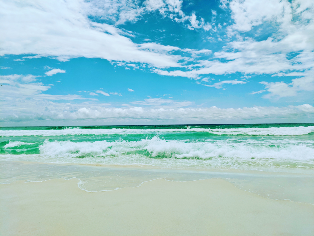 Waves lapping the white sand beach during the best time to visit Destin Florida