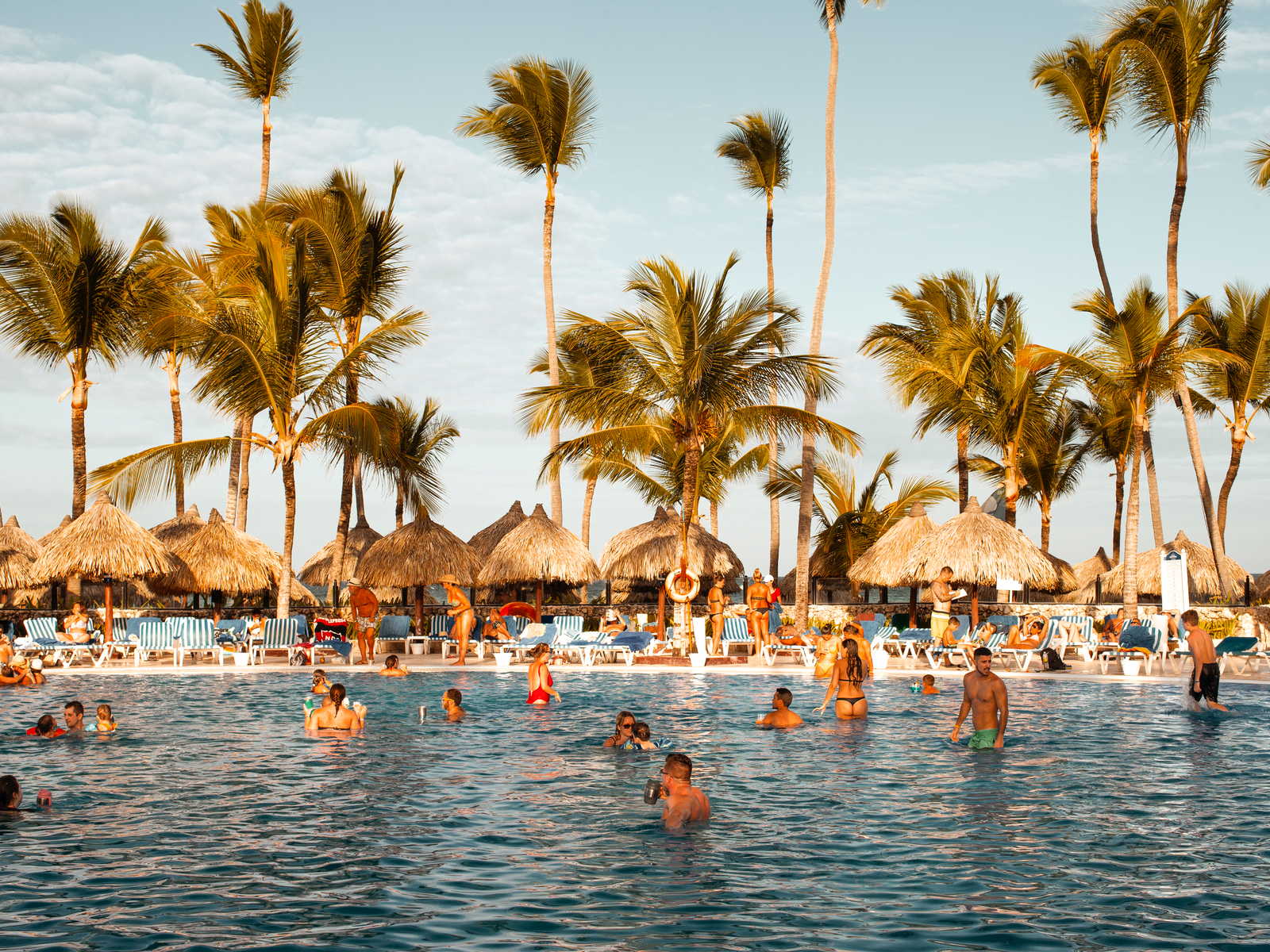 Many couples on their swimwear dipping by the large pool at Bahia Principe Grand Bavaro, known as one of the best all-inclusive resorts in Punta Cana