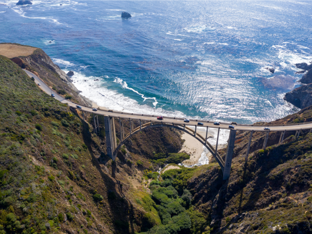 Cars traversing the Bixby Bridge on the Pacific Coast Highway near Big Sur, one of the best things to do in California