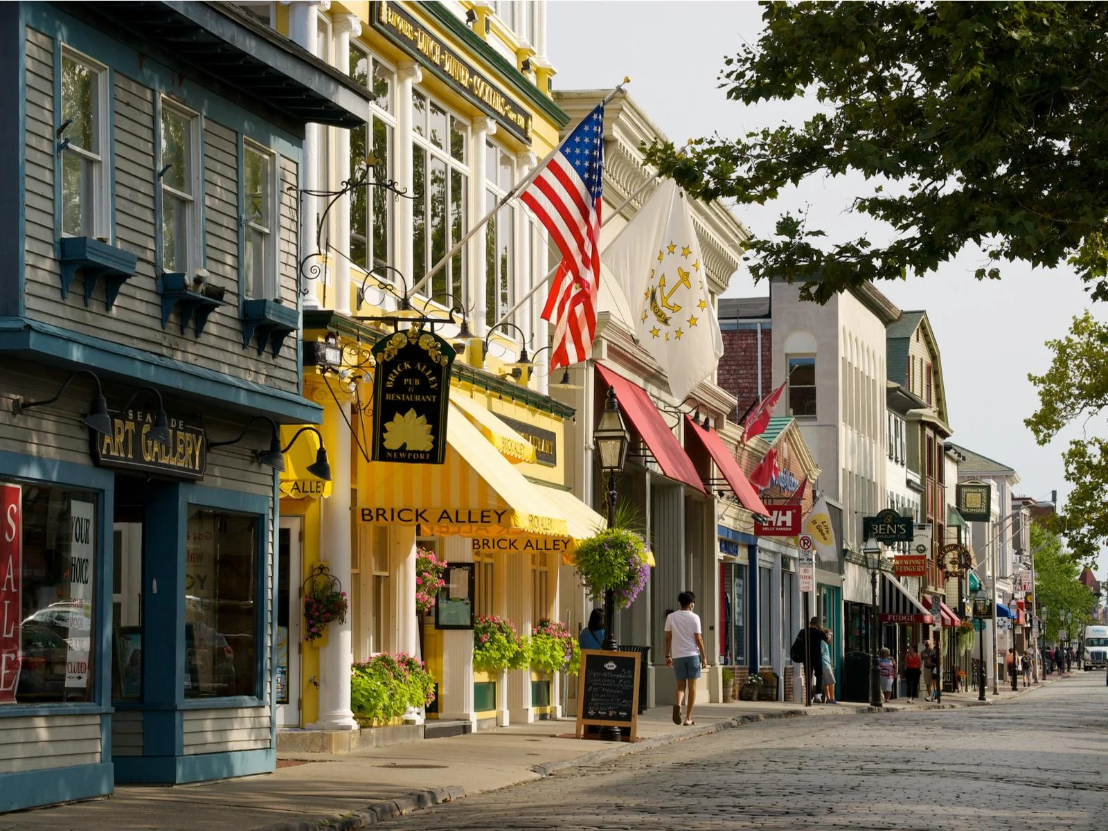 Locals walking past classic store within the historic structures at the seaside city of Newport in Rhode Island, one of the most beautiful cities in the US