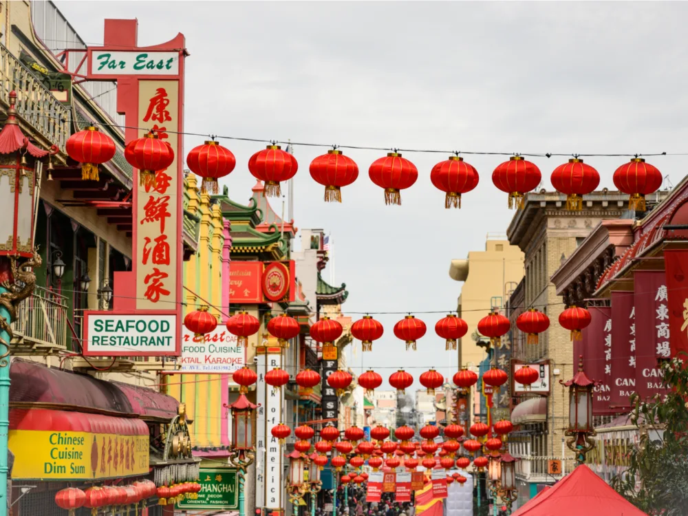 Red lanterns over several restaurants in a China Town, and grabbing some Dim Sum is one of the best things to do in California