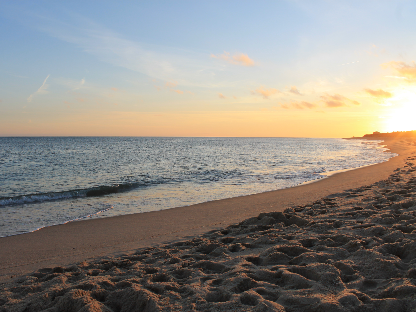 Beautiful sunrise over the calm Cisco Beach on Nantucket Island in Massachusetts, one of the best beaches on the East Coast, with sands walked on by many visitors