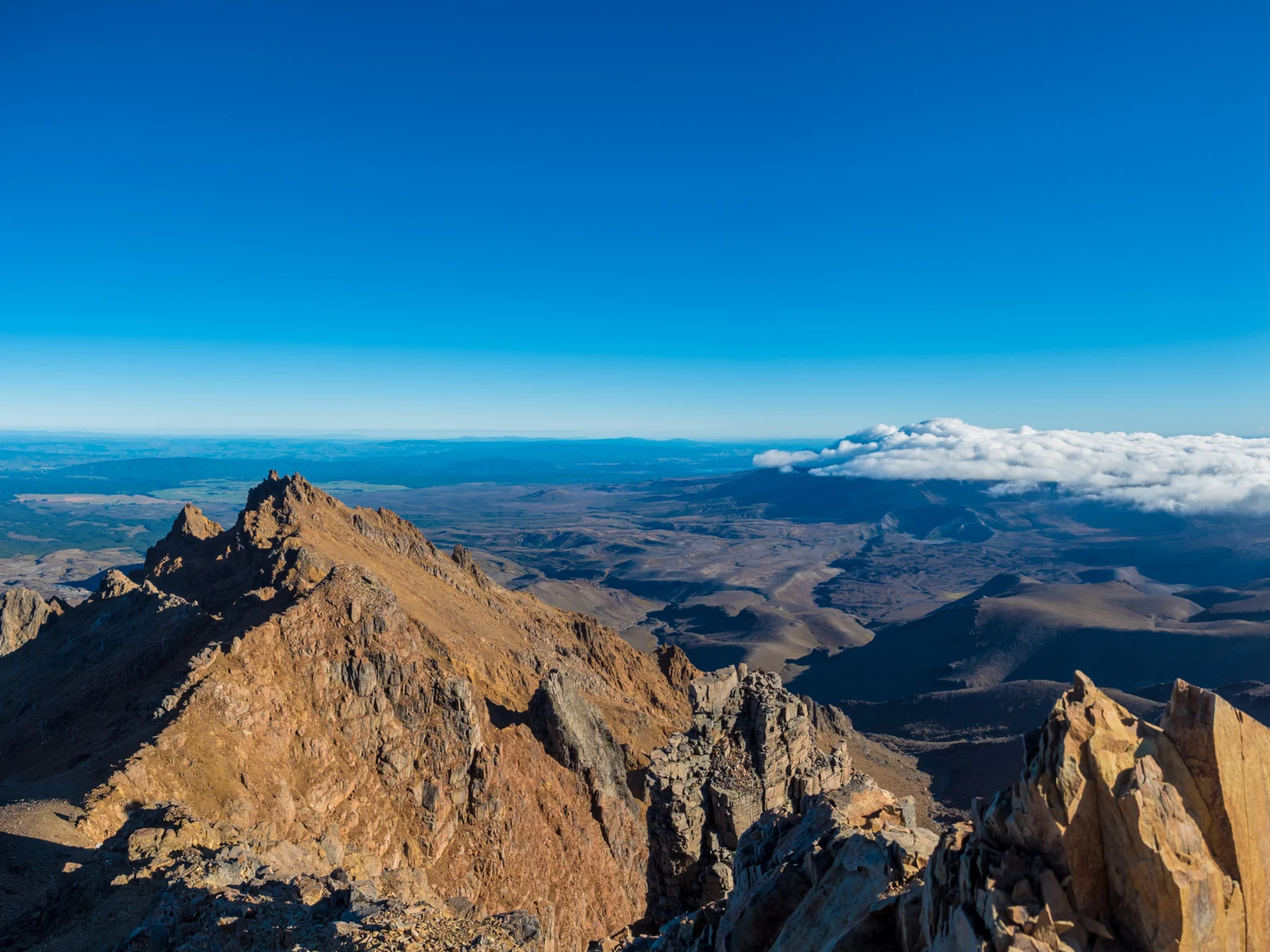 Peak of Mount Ruapehu during summer, with rocky and parched ground, is one of the Lord of the Rings Filming Locations you can climb