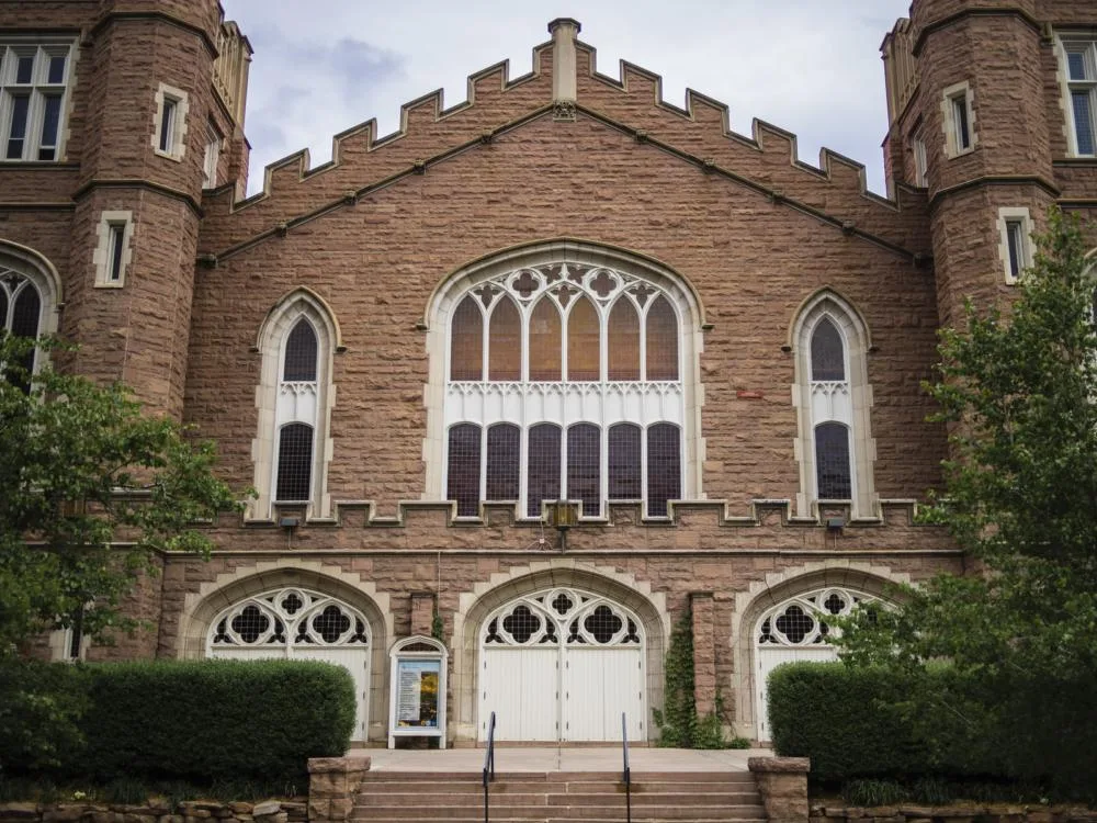 The historic Macky Auditorium at University of Colorado Boulder in Colorado, one of the most beautiful college campuses, with three wide doors and colored glass windows
